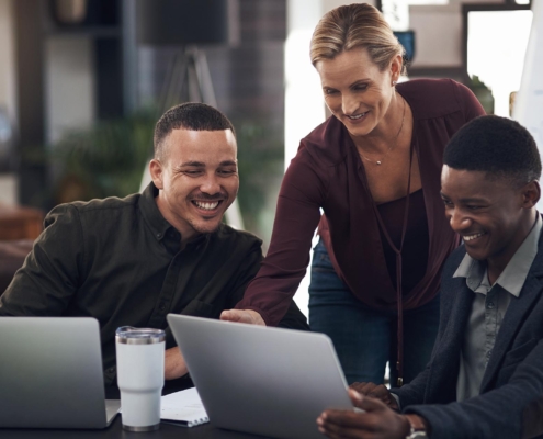 Office Workers Communicating Around Laptop