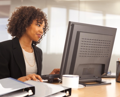 Tech Professional On Computer In Office