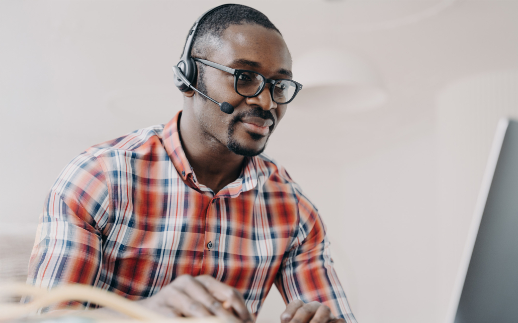 Services Worker Wearing Headset Working At Laptop