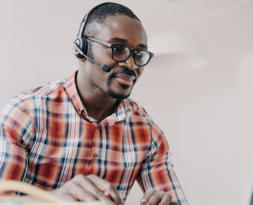 Services Worker Wearing Headset Working At Laptop