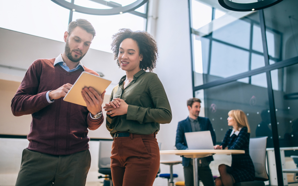 Workers In Office Looking At Technology