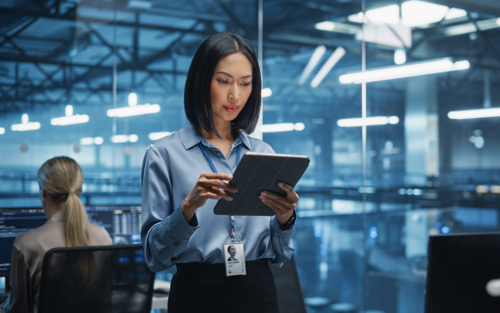 Cybersecurity Expert Works On Her Tablet Computer In A Modern Facility
