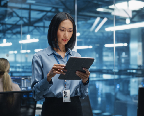 Cybersecurity Expert Works On Her Tablet Computer In A Modern Facility