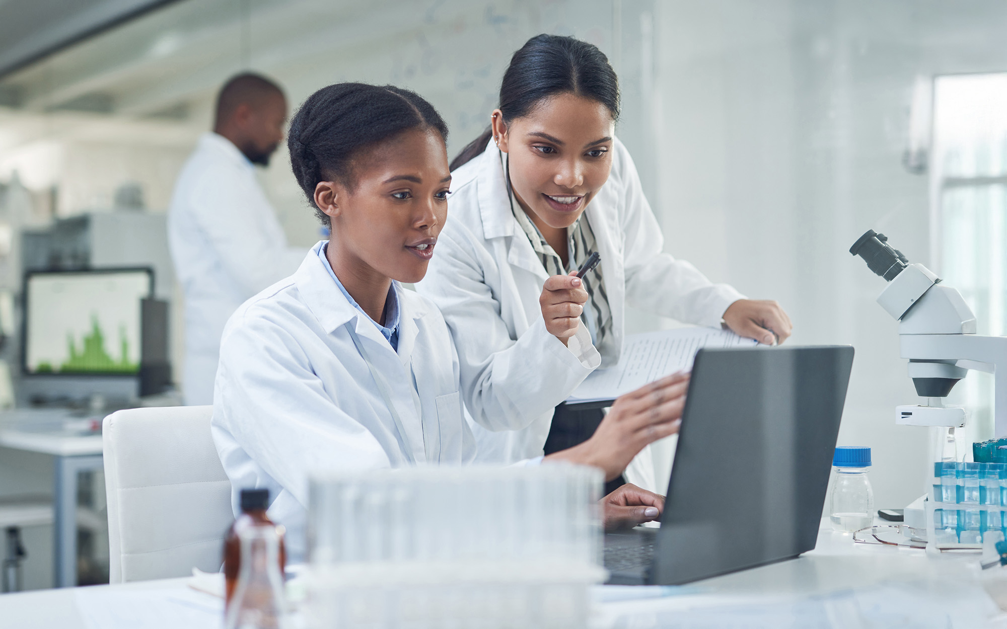 Shot Of Two Young Scientists Using A Laptop In A Laboratory