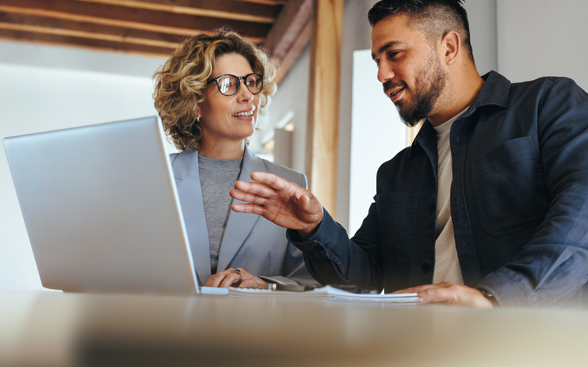 Business man having a discussion with his colleague in an office Business Man Having A Discussion With His Colleague In An Office