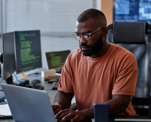 Portrait Of Black Software Engineer Using Computer In High Technology Office